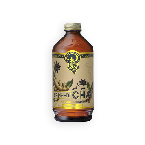 A bottle of Bright Char Flower Relief Concentrate syrup, featuring an amber glass bottle with a beige label and gold cap, set against a plain white background.