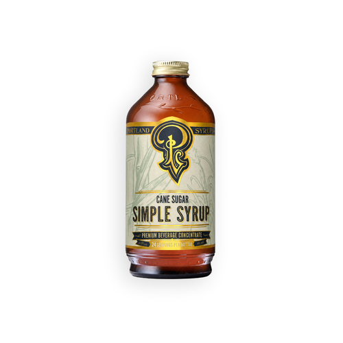 A bottle of Island Simple Syrup with a cream-colored label and gold accents, containing amber-colored liquid, set against a plain white background.