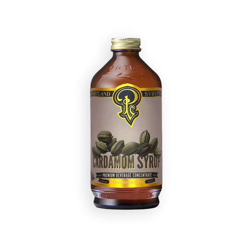 A bottle of Portland Syrup Cardamom Syrup, featuring an amber glass bottle with a beige label, green cardamom pods illustration, and a gold cap, set against a plain white background.