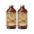 Two amber glass bottles of Portland Syrup Passion Fruit Citrus beverage concentrate with gold caps and orange labels, shown side by side on a white background.