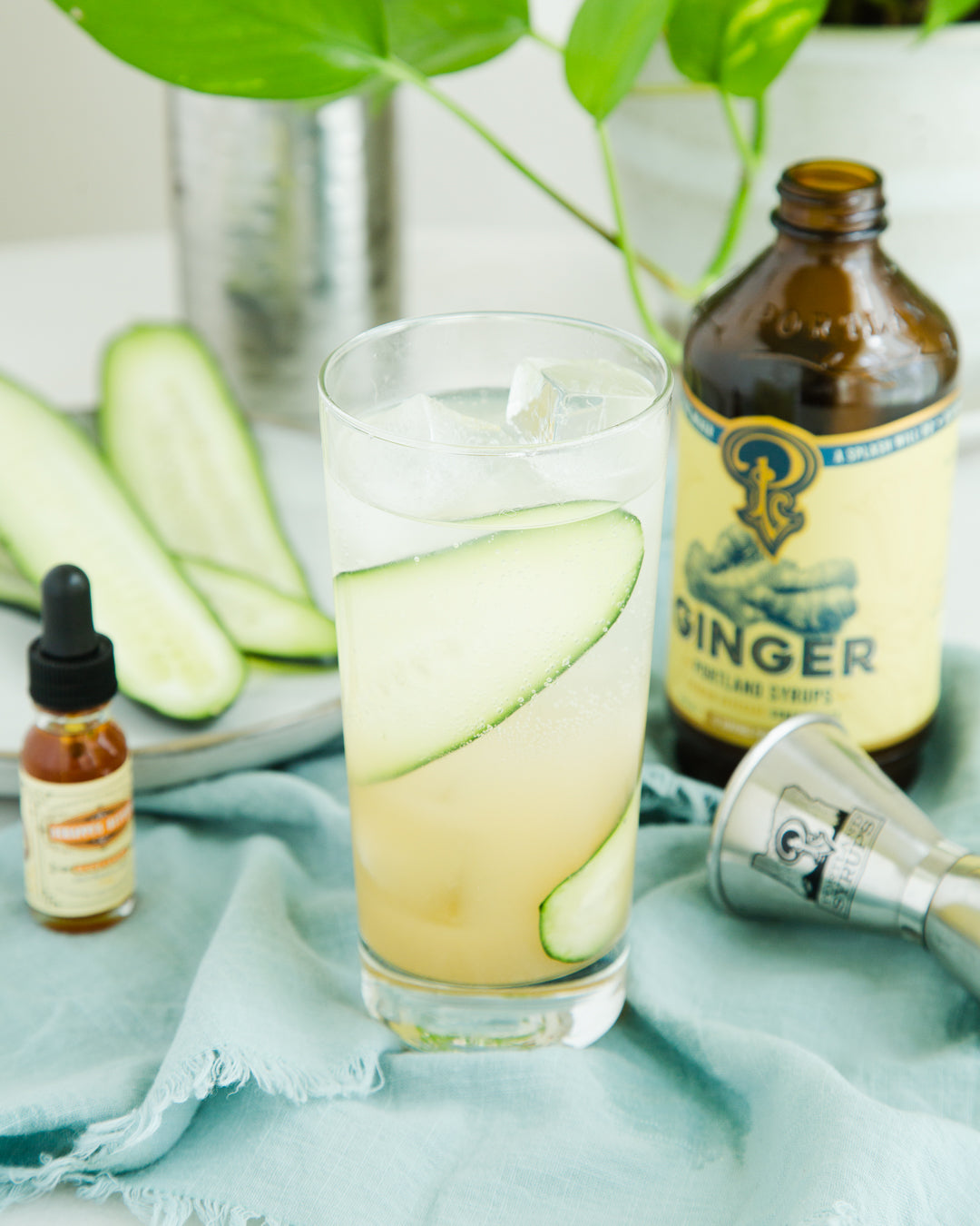 Cucumber ginger drink with ingredients on a light blue cloth
