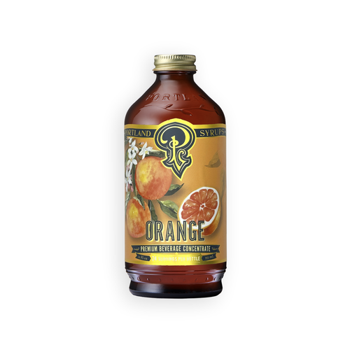 A bottle of Syrupland Premium Beverage Concentrate Orange flavor, featuring an amber glass bottle with a gold cap and a yellow-orange label decorated with illustrations of oranges and white blossoms.