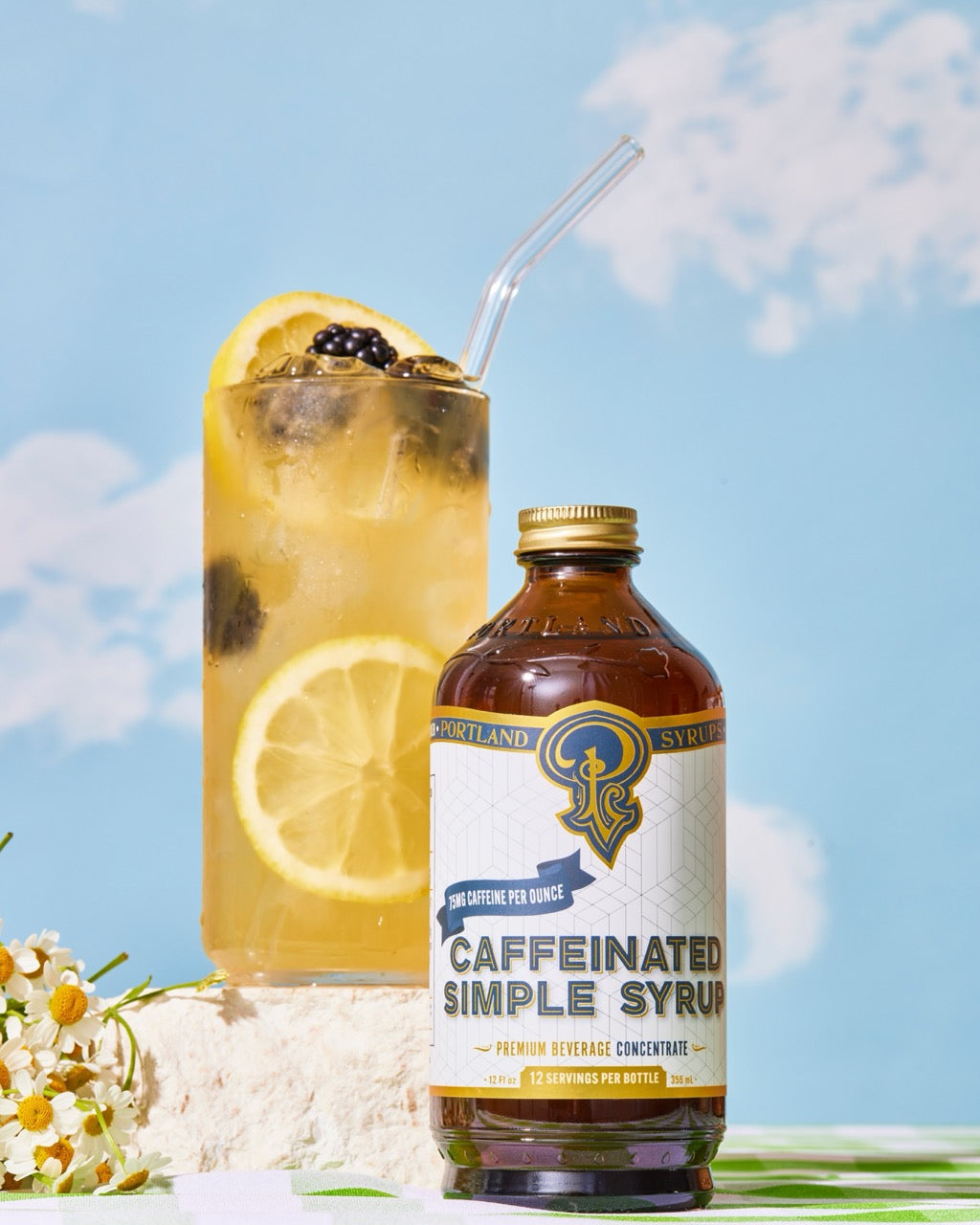 Bottle of 'Caffeinated Simple Syrup' with a lemonade drink on a bright background