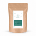A kraft paper stand-up pouch of Palm & Pine Coffee with a white and green label, photographed on a clean white background.